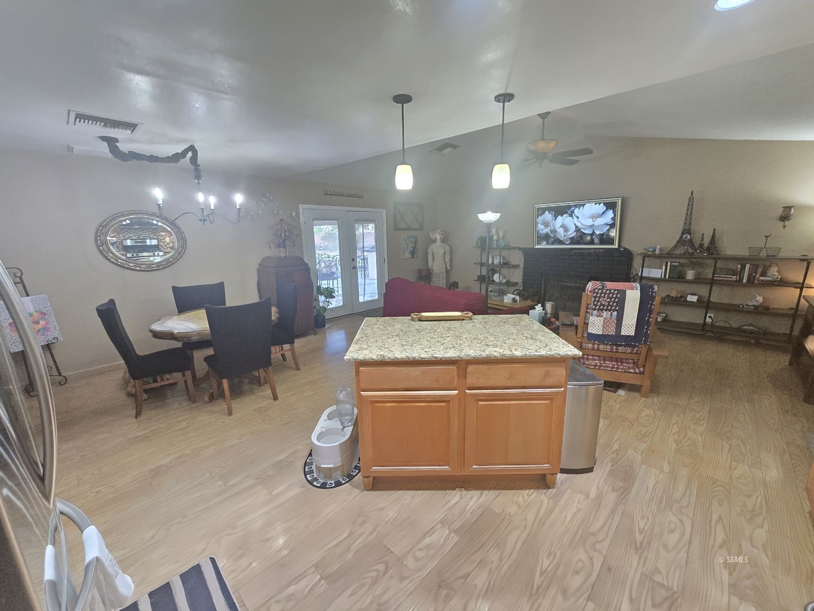 201 East Benson Avenue Ridgecrest, CA 93555 - Photo 9 of 35 a living room with furniture a clock and wooden floor