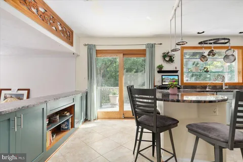 a kitchen with stainless steel appliances granite countertop a stove refrigerator and cabinets