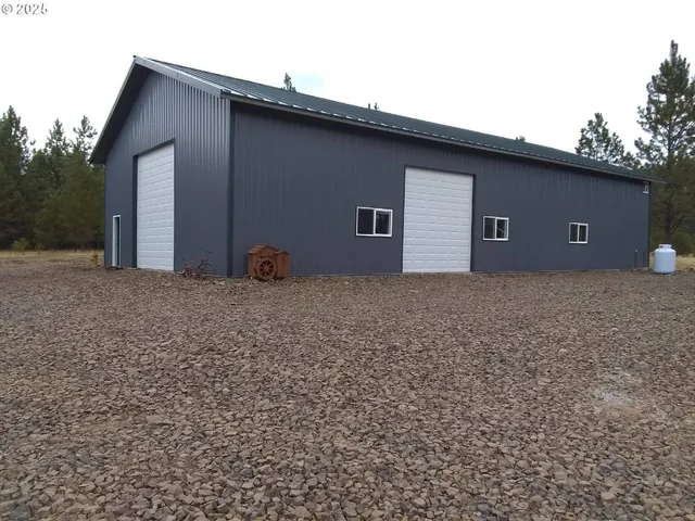 a front view of a house with a tree