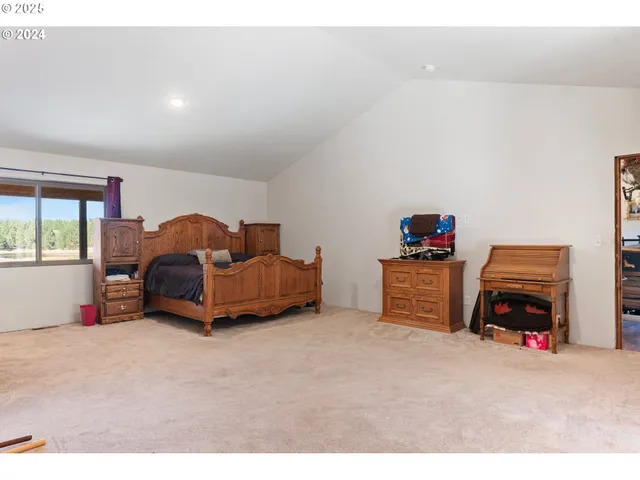 a living room with a couch and a baby crib