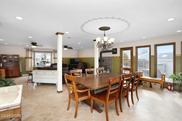 a view of a dining room with furniture large windows and wooden floor