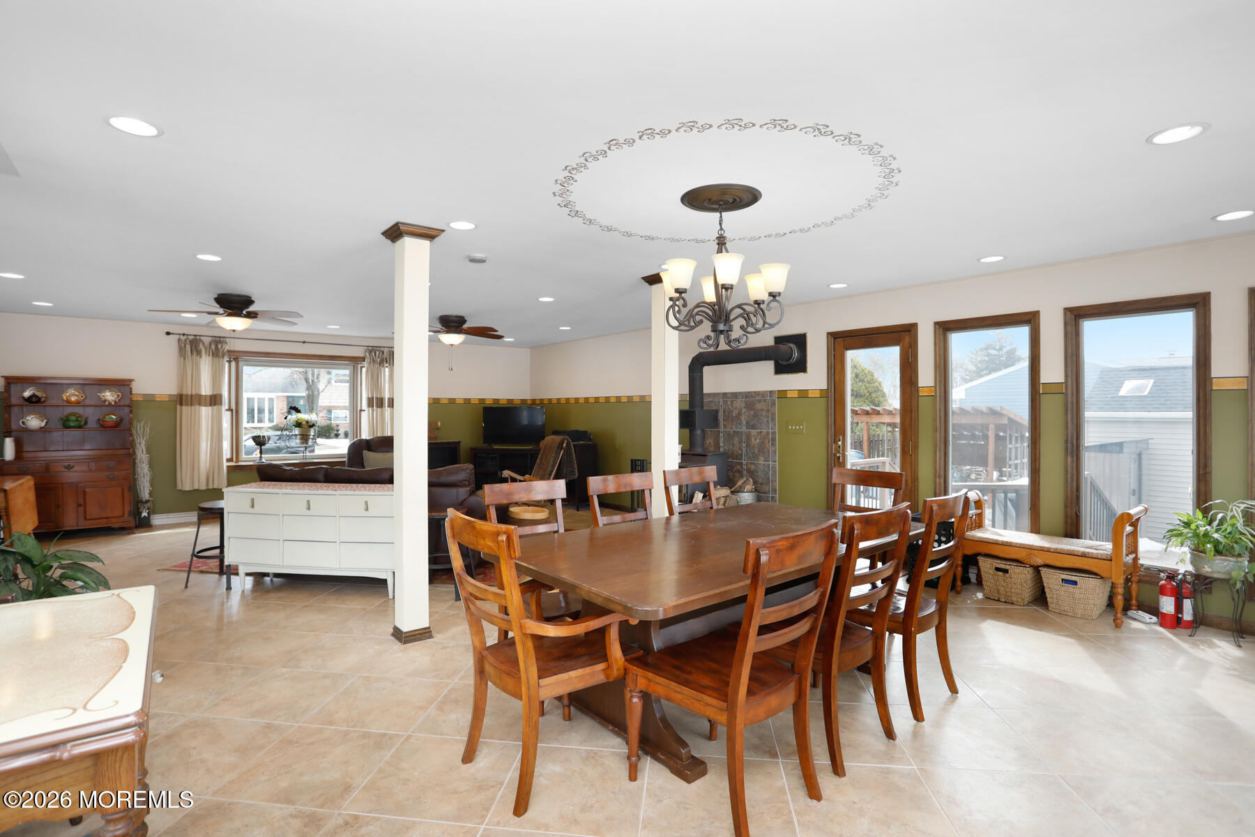 a view of a dining room with furniture large windows and wooden floor