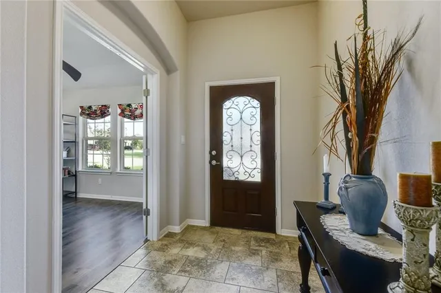 a view of a livingroom with furniture and a window