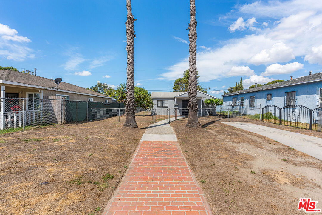 15321 South Frailey Avenue Compton, CA 90221 - Photo 1 of 19 a front view of a building with pathway
