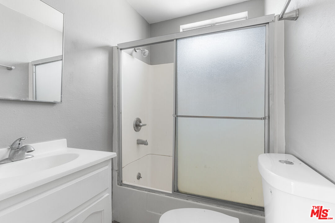 15321 South Frailey Avenue Compton, CA 90221 - Photo 9 of 19 a bathroom with a sink toilet and shower