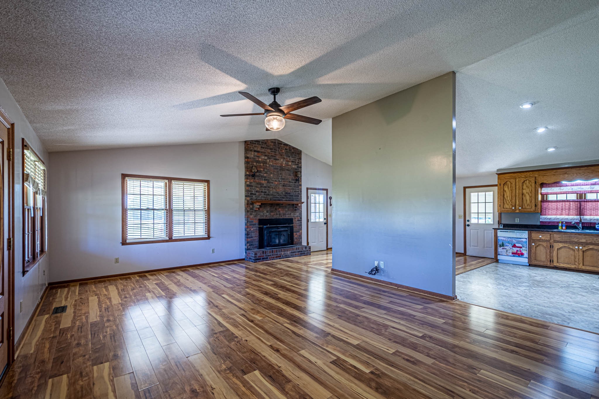 2515 Briar Patch Road Prospect, TN 38477 - Photo 3 of 43 an empty room with wooden floor fireplace and windows