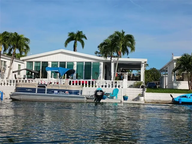 a view of swimming pool with table and chairs under an umbrella