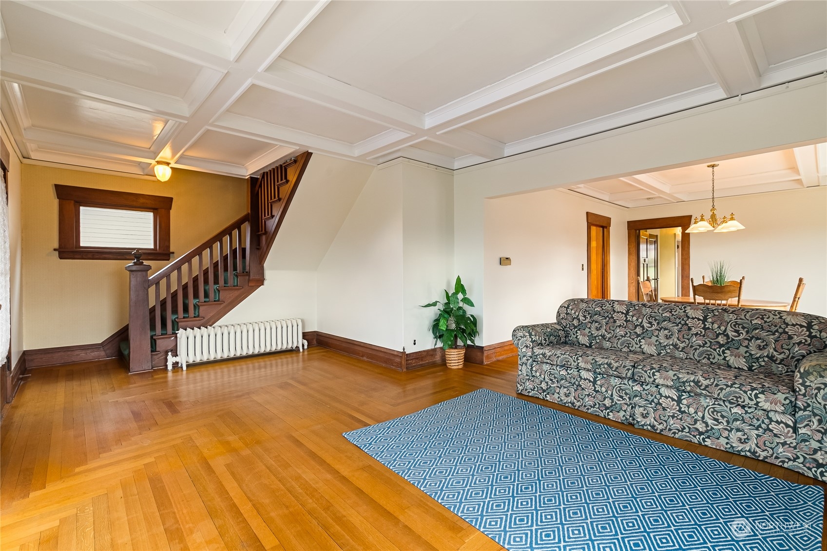 1015 14th Street Bellingham, WA 98225 - Photo 19 of 40 a living room with furniture and a dining table with wooden floor