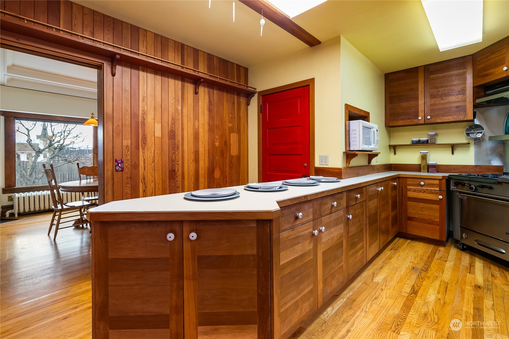 1015 14th Street Bellingham, WA 98225 - Photo 23 of 40 a kitchen with stainless steel appliances granite countertop a sink stove and wooden floor