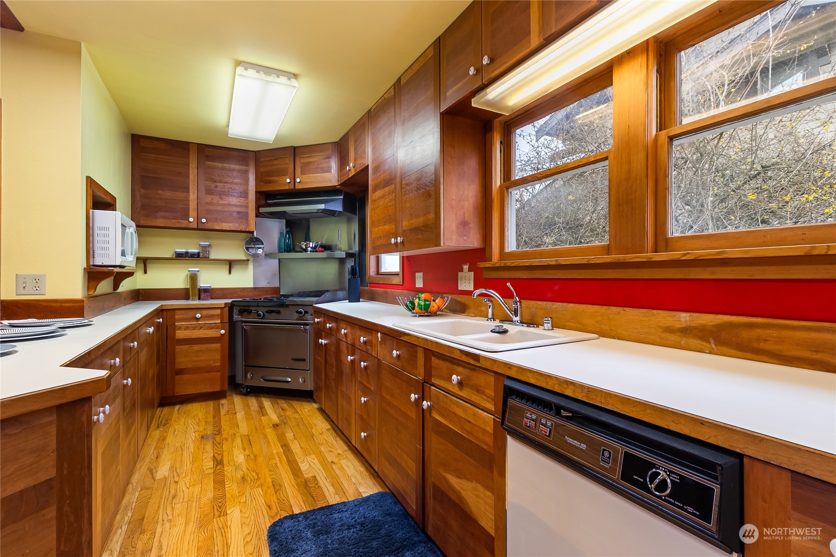 1015 14th Street Bellingham, WA 98225 - Photo 25 of 40 a kitchen with stainless steel appliances sink cabinets and window