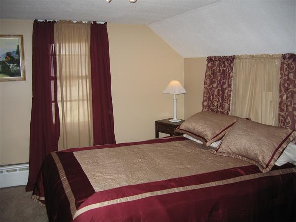 350 Granby Road Chicopee, MA 01013 - Photo 16 of 28 a bedroom with a bed and a lamp with the outer view