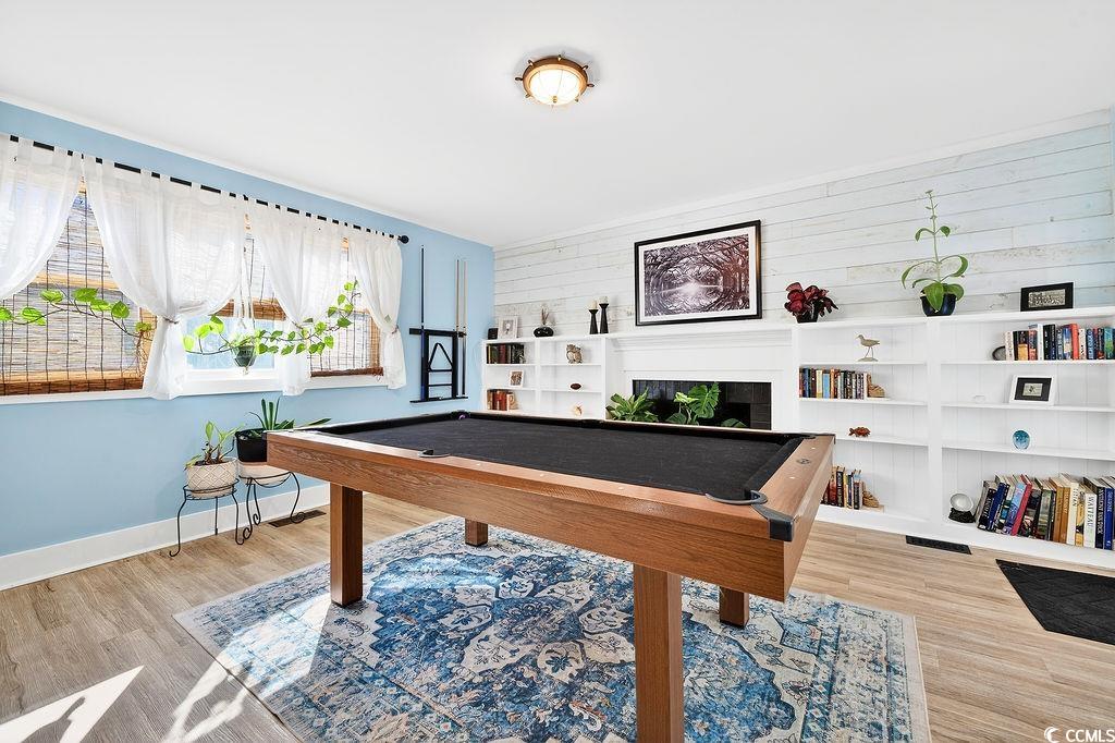 1137 Palmetto Street Georgetown, SC 29440 - Photo 16 of 40 Game room featuring billiards, a fireplace, light wood-style floors, and wood walls