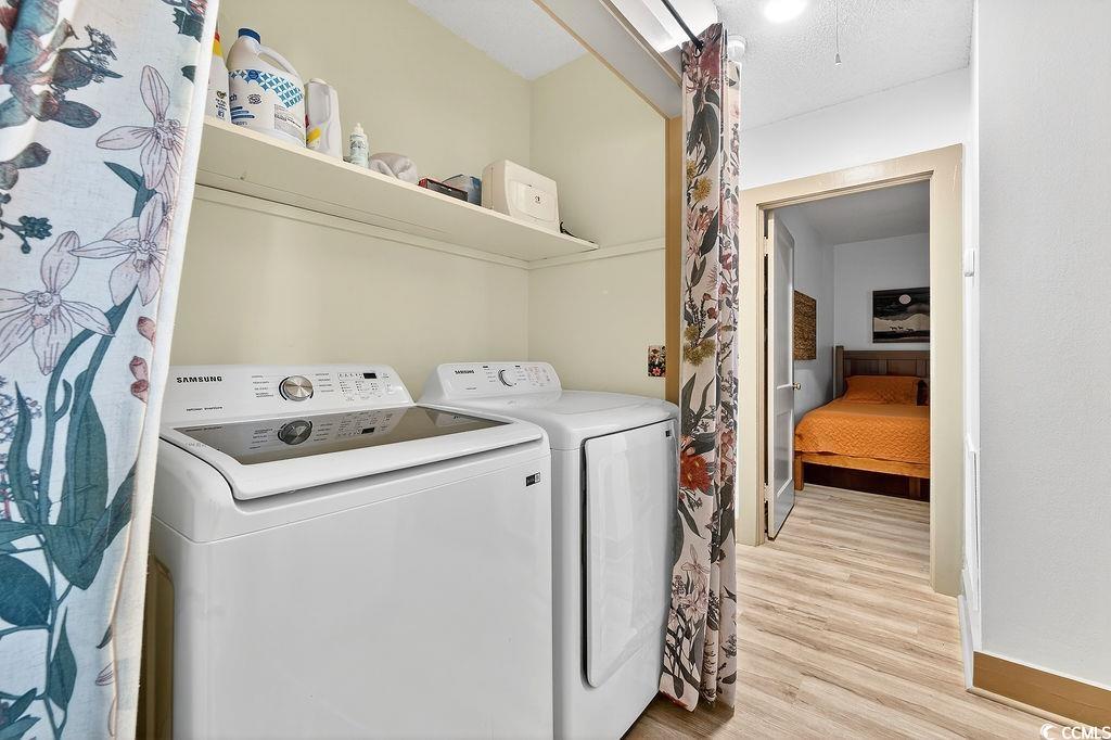 1137 Palmetto Street Georgetown, SC 29440 - Photo 22 of 40 Laundry area featuring washer and clothes dryer and light wood-style flooring