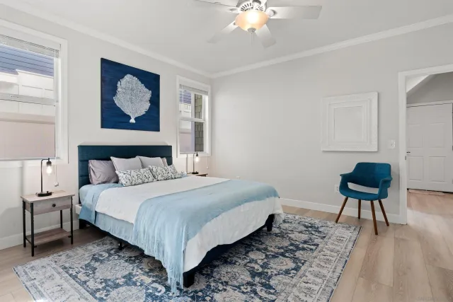 a bedroom with a bed and a chandelier