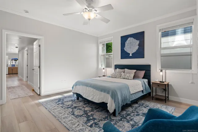 a spacious bedroom with a bed and a chandelier