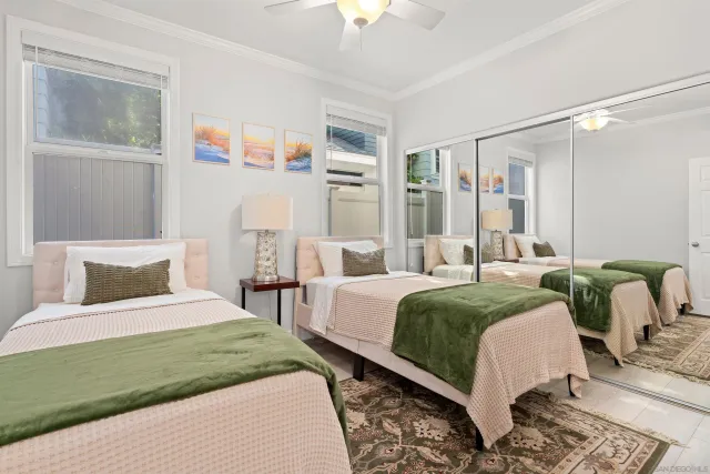 a bedroom with a bed wooden floor and window