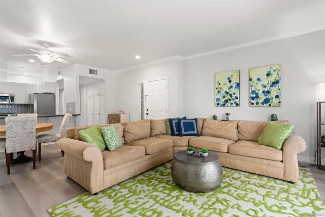 a living room with furniture and painting on the wall