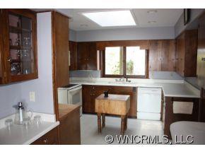 1695 Hogback Mountain Road Tryon, NC 28782 - Photo 5 of 12 a kitchen with granite countertop a stove a sink and a refrigerator
