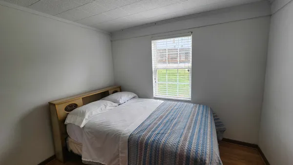a bedroom with a bed and a window
