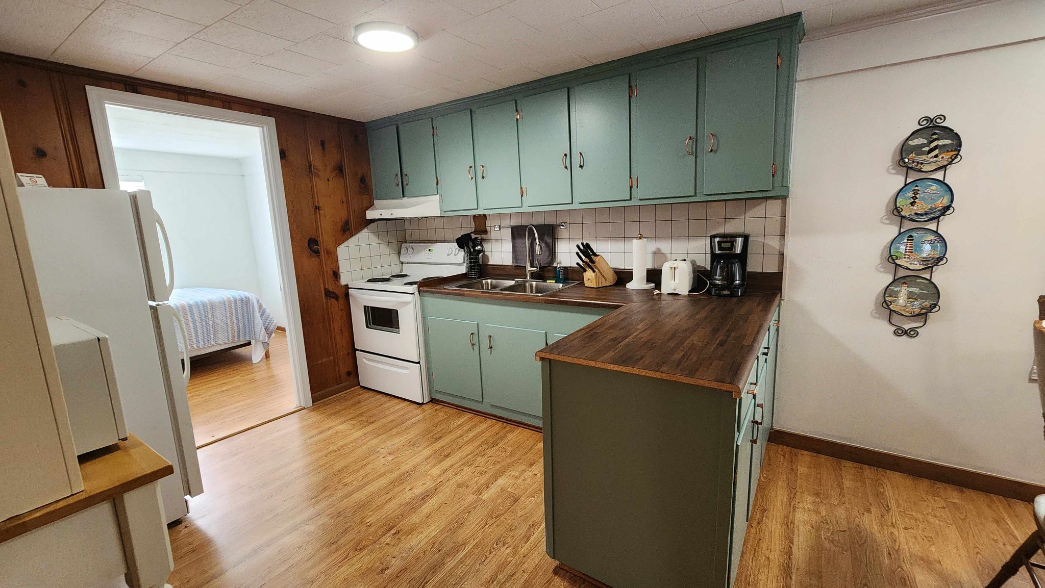 228 Bill Hunter Road Celina, TN 38551 - Photo 29 of 57 a kitchen with a refrigerator a stove top oven a sink and dishwasher