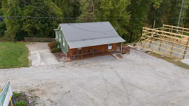 a view of a house with backyard space and wooden fence