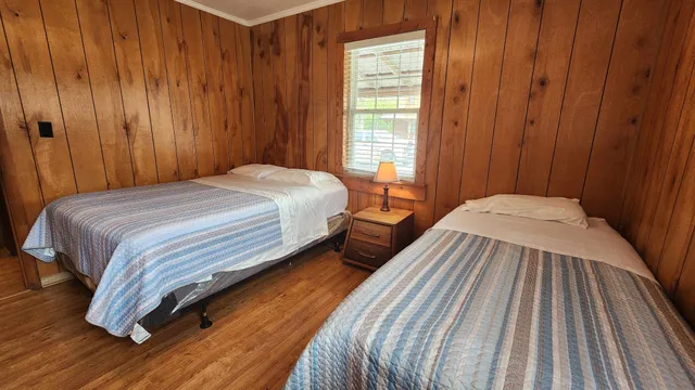 a bedroom with a bed and a window