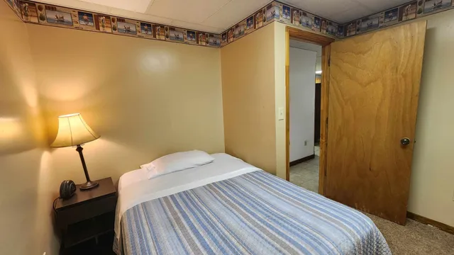 a bedroom with a bed and a mirror