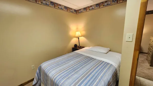 a bedroom with a bed and a mirror