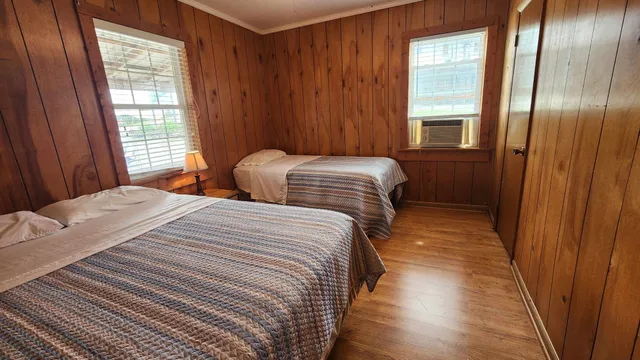 a bedroom with double bed and a window