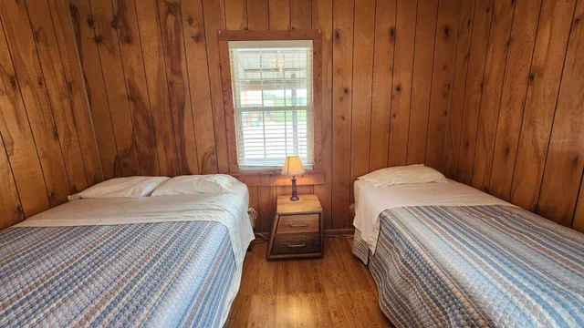 a bedroom with a bed and a wooden floor