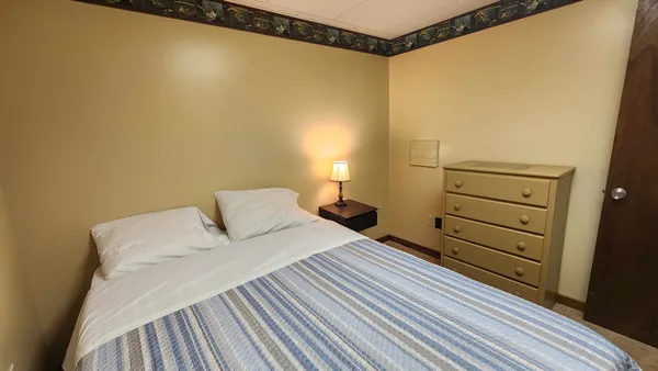 a bedroom with a bed and a dresser