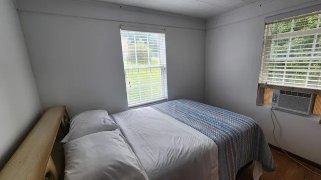 a bedroom with a bed and a window