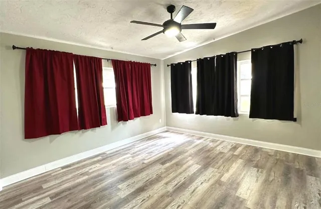 a view of a livingroom with a ceiling fan and window
