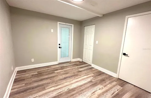 a view of an empty room and wooden floor