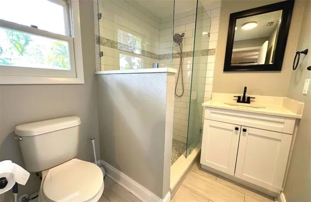 a bathroom with a toilet sink and a mirror
