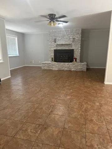 a view of empty room with fireplace