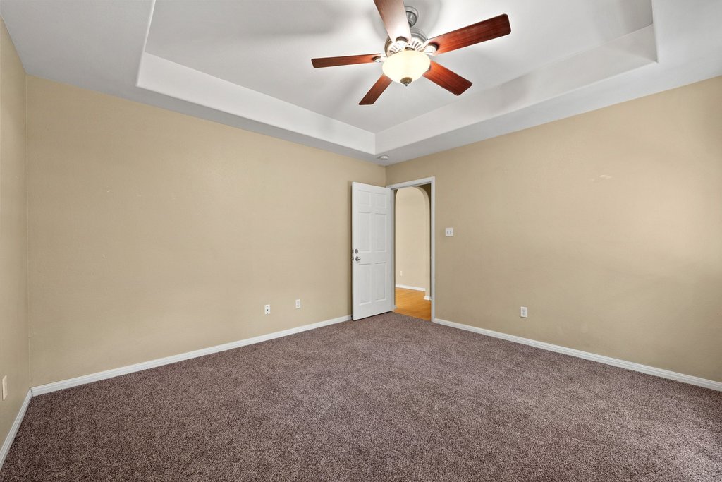 5208 Sioux Lane Austin, TX 78734 - Photo 22 of 35 A quiet retreat with a classic ceiling fan and plush carpeting.