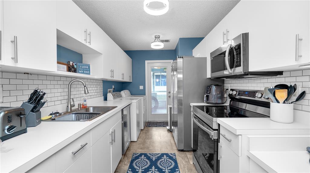 628 Ridge Terrace Winter Haven, FL 33881 - Photo 11 of 44 a kitchen with a sink stove and cabinets