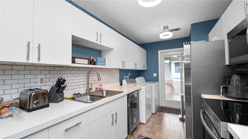 628 Ridge Terrace Winter Haven, FL 33881 - Photo 12 of 44 a kitchen with a sink and refrigerator