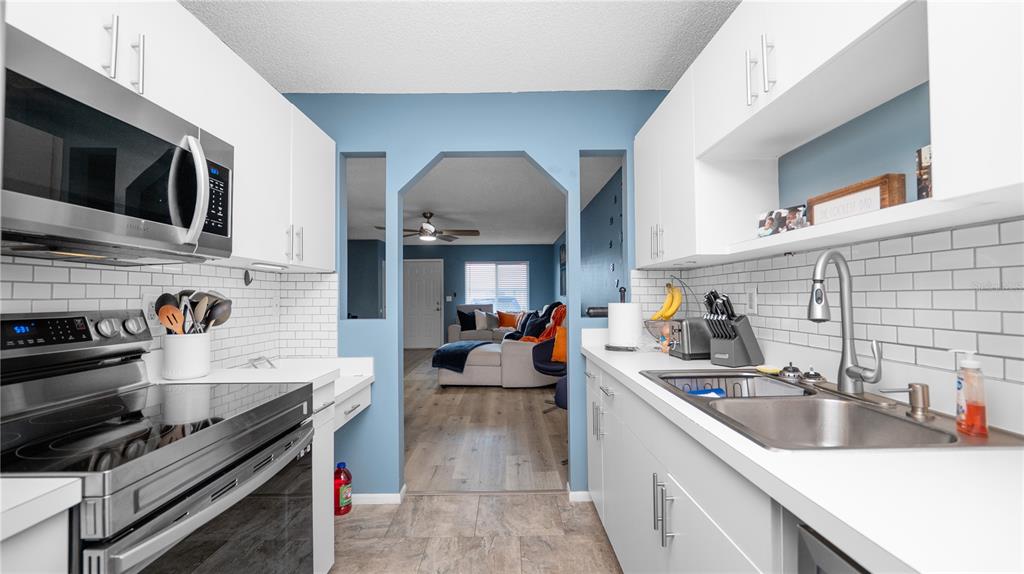 628 Ridge Terrace Winter Haven, FL 33881 - Photo 15 of 44 a kitchen with stainless steel appliances a sink dishwasher stove and oven