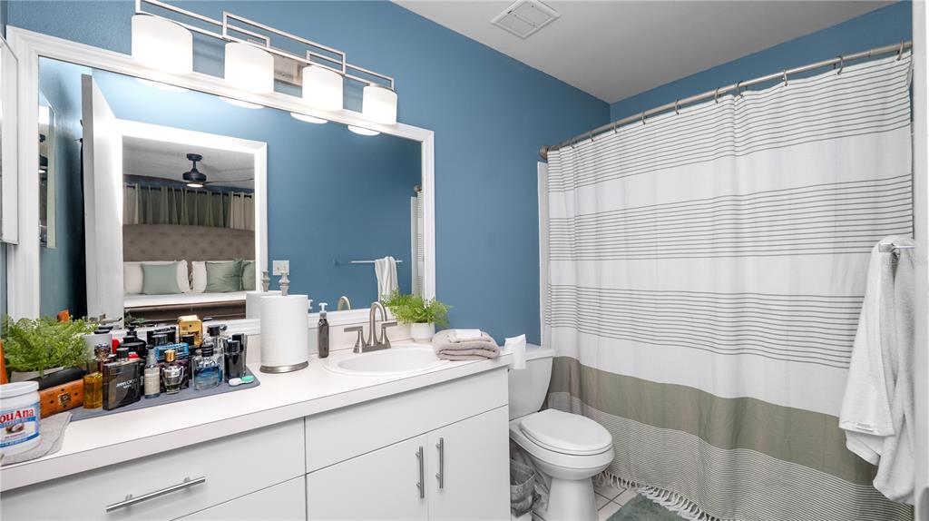 628 Ridge Terrace Winter Haven, FL 33881 - Photo 19 of 44 a bathroom with a sink a toilet a shower and a mirror