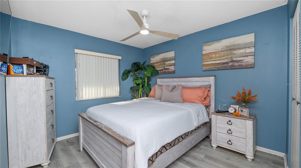 628 Ridge Terrace Winter Haven, FL 33881 - Photo 21 of 44 a bedroom with a large bed and a chandelier