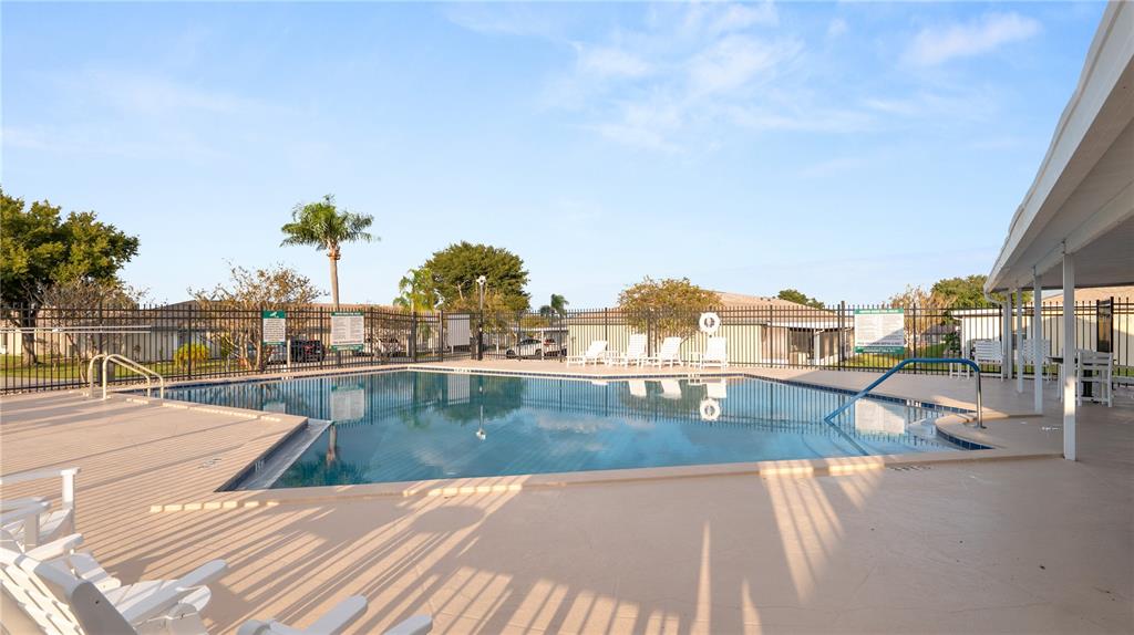 628 Ridge Terrace Winter Haven, FL 33881 - Photo 32 of 44 a view of a swimming pool with a lounge chairs