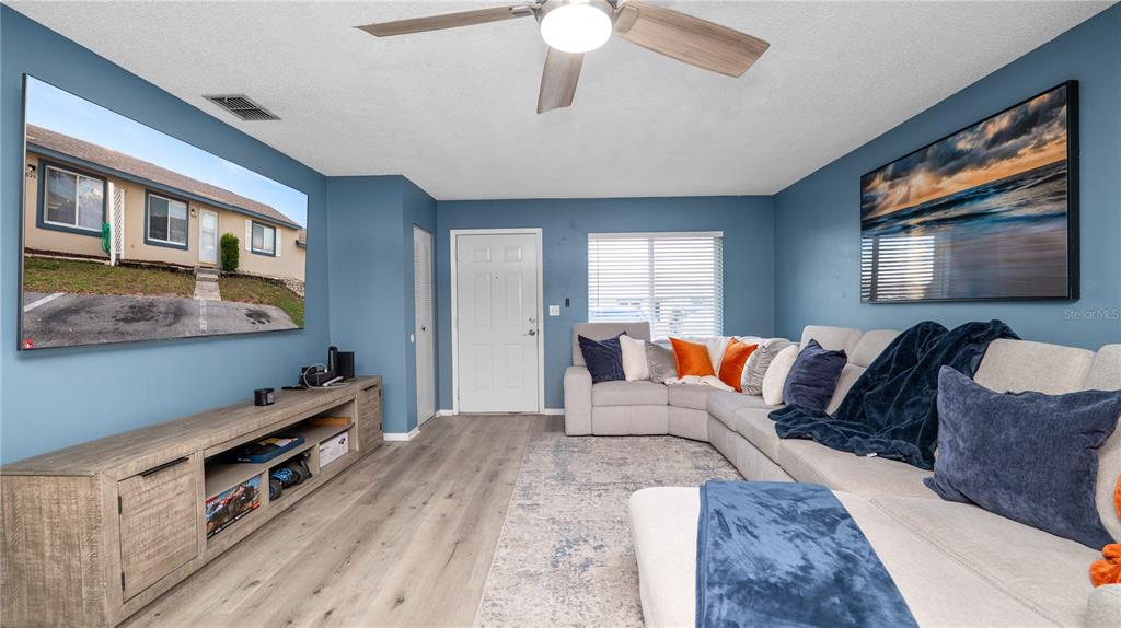 628 Ridge Terrace Winter Haven, FL 33881 - Photo 6 of 44 a living room with furniture and a flat screen tv