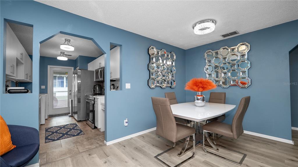 628 Ridge Terrace Winter Haven, FL 33881 - Photo 10 of 44 a view of a dining room with furniture and wooden floor