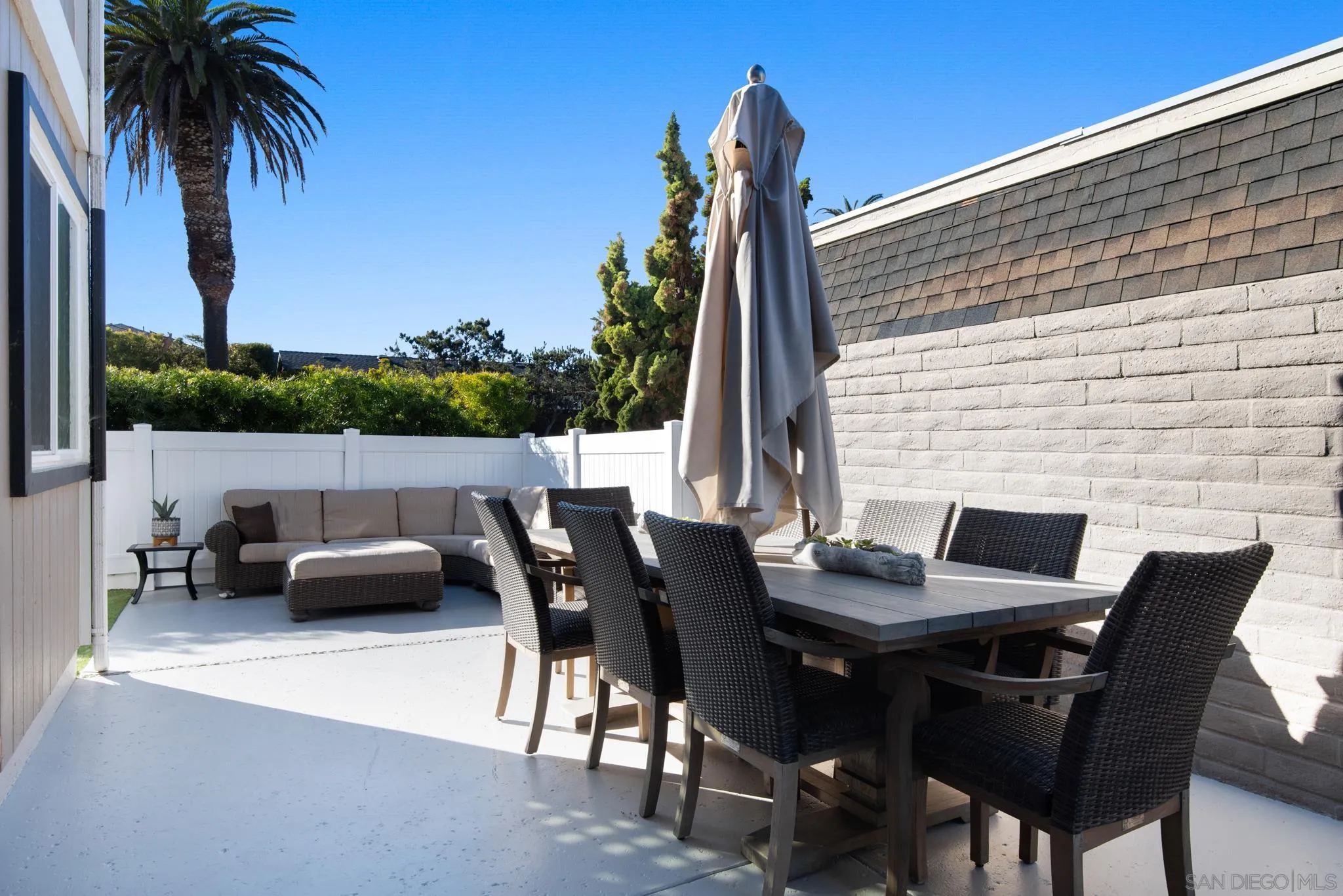 1933 Coast Boulevard Del Mar, CA 92014 - Photo 18 of 47 a backyard of a house with dining table and chairs