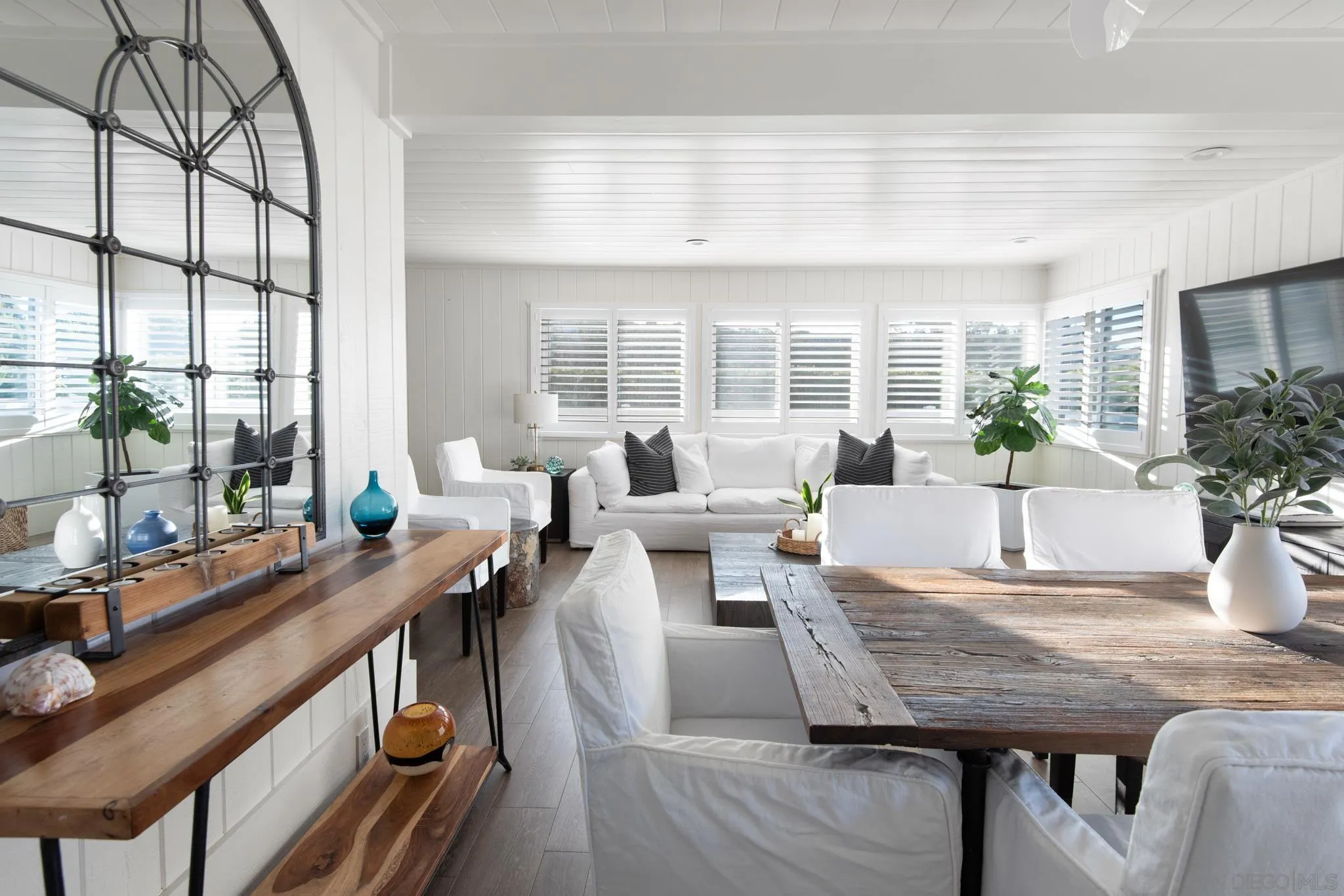 1933 Coast Boulevard Del Mar, CA 92014 - Photo 26 of 47 a living room with furniture a large window and wooden floor