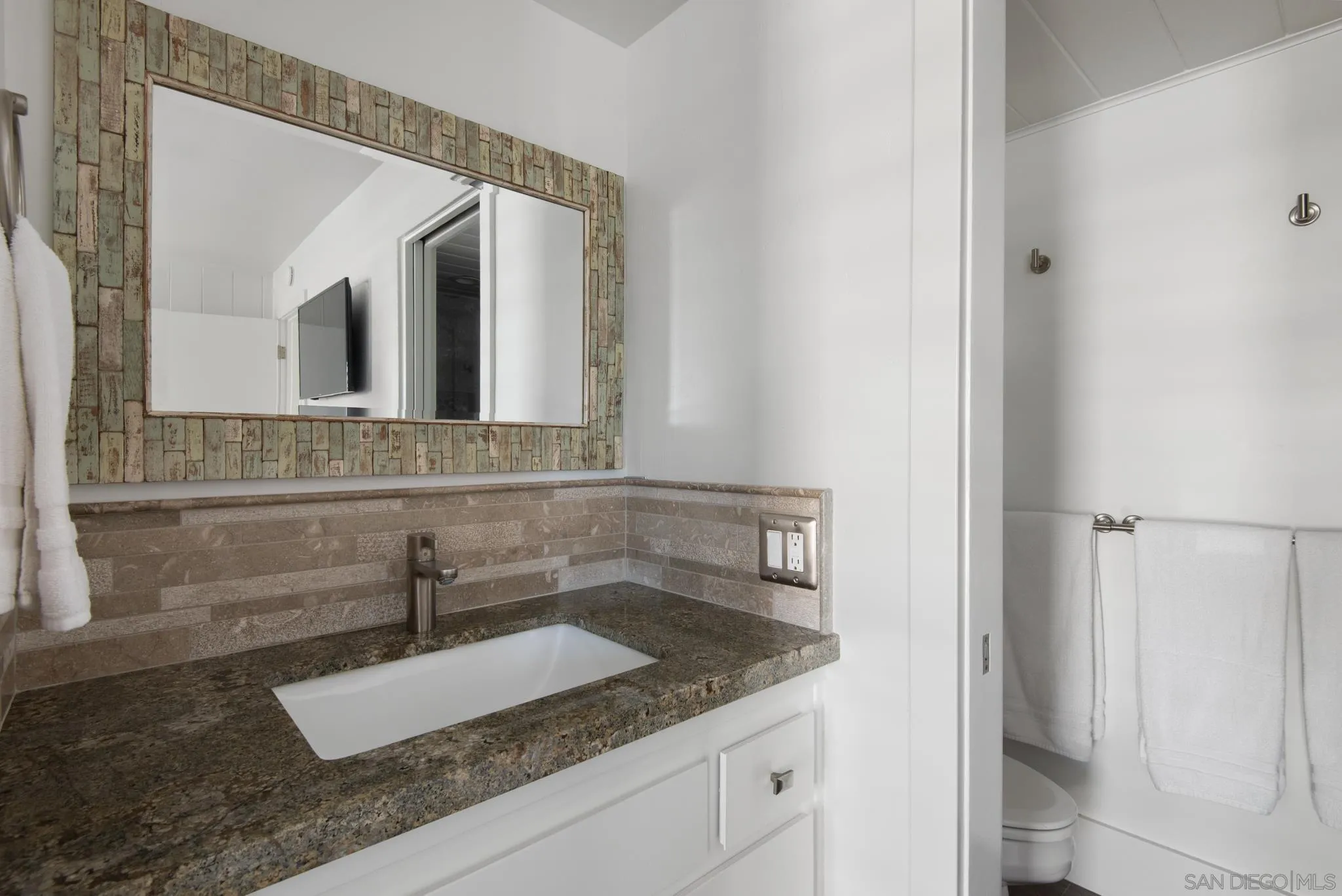 1933 Coast Boulevard Del Mar, CA 92014 - Photo 32 of 47 a bathroom with a granite countertop sink and mirror