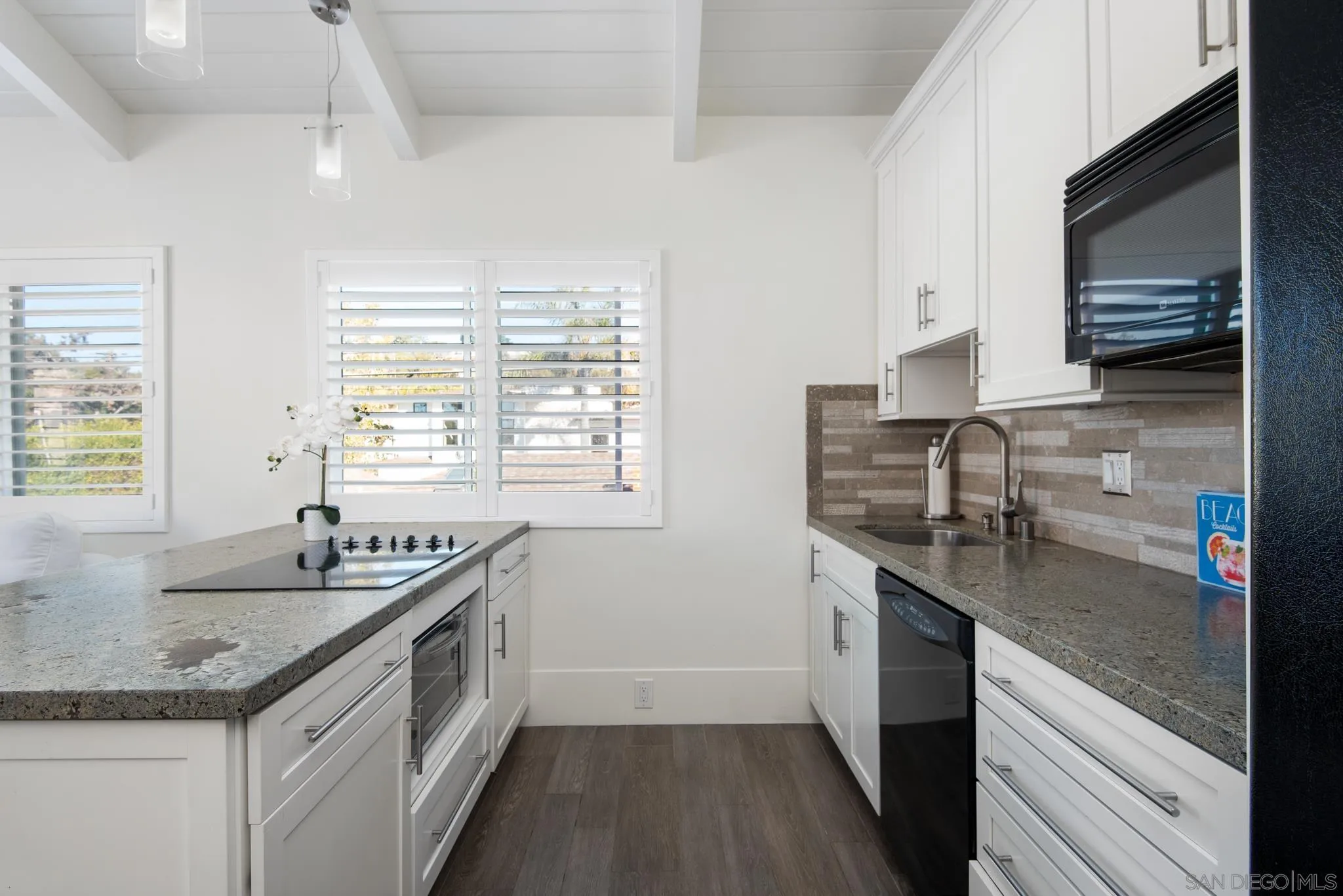 1933 Coast Boulevard Del Mar, CA 92014 - Photo 40 of 47 a kitchen with stainless steel appliances granite countertop a sink stove and cabinets