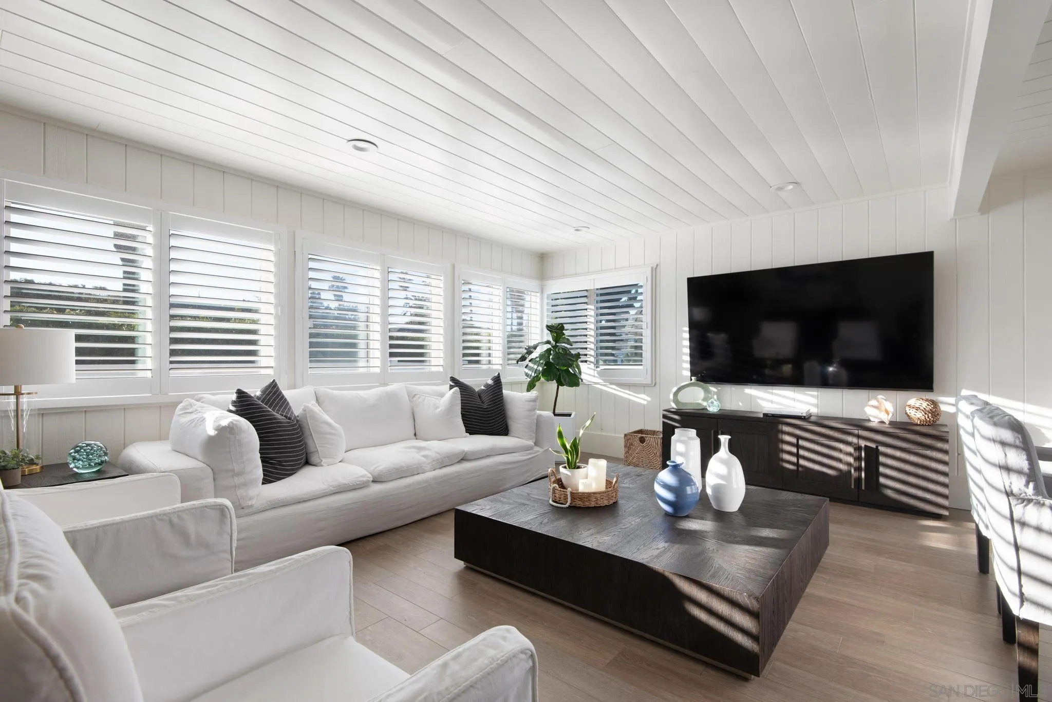 1933 Coast Boulevard Del Mar, CA 92014 - Photo 4 of 47 a living room with furniture flat screen tv and a large window